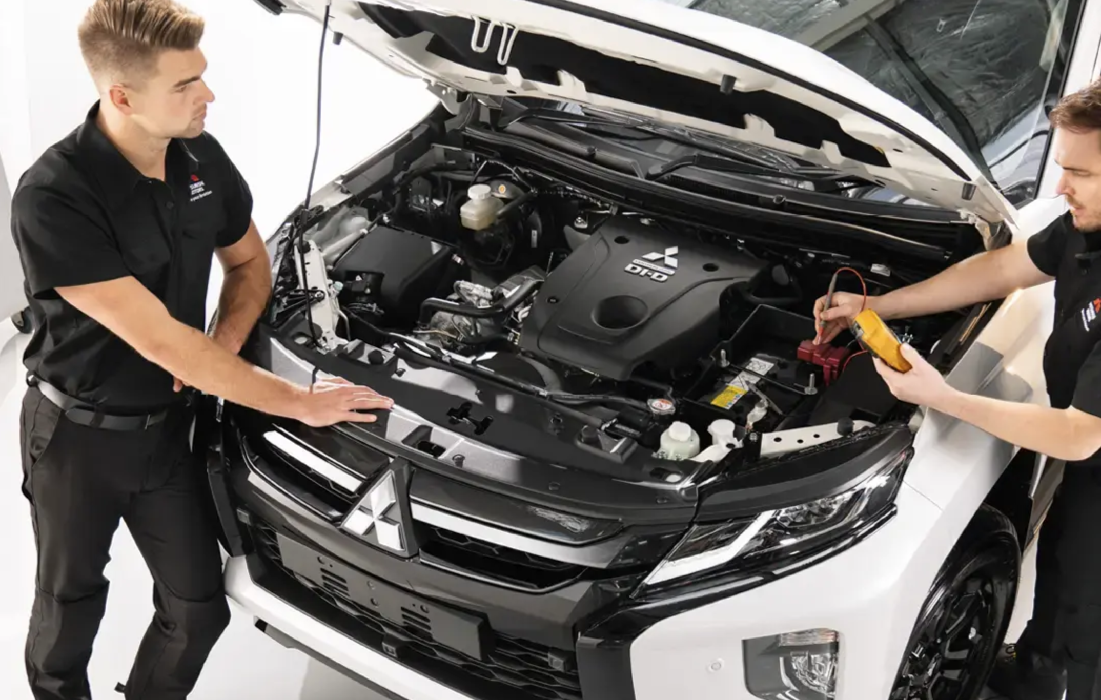 white Mitsubishi being serviced